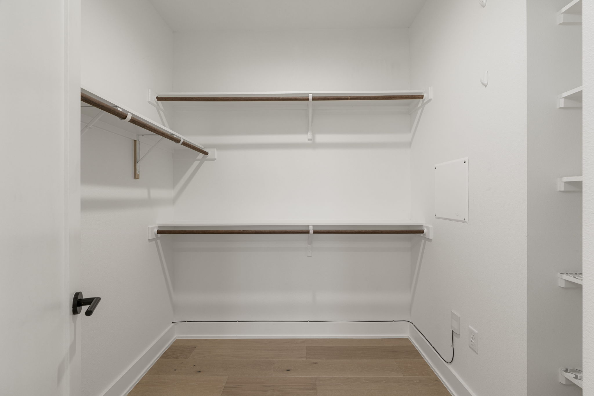 1405 Perez Street, Unit 1 Austin, TX 78721 - Photo 23 of 31 Spacious walk-in closet with dual hanging rods and built-in shelving for organized storage.