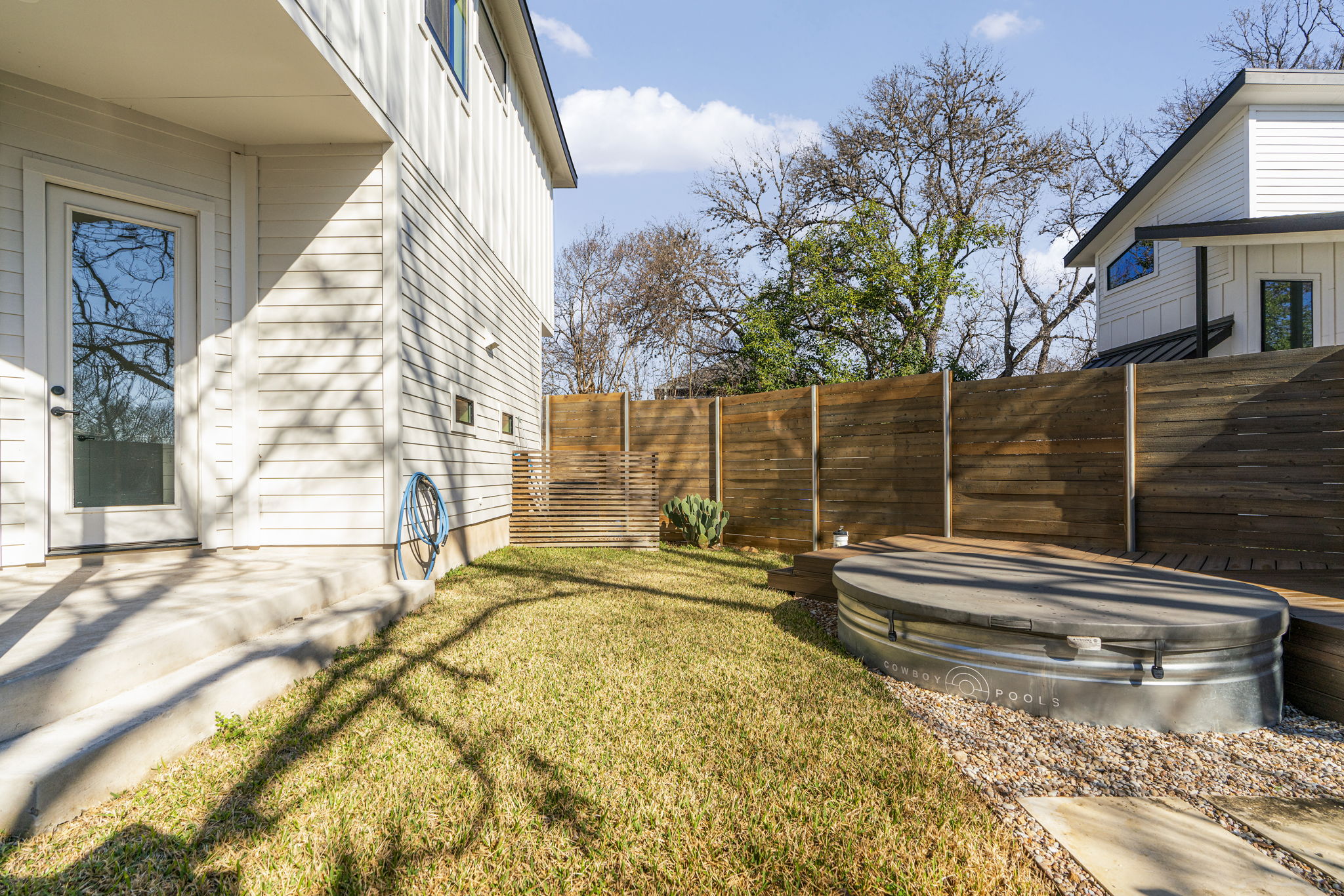 1405 Perez Street, Unit 1 Austin, TX 78721 - Photo 28 of 31 Fully fenced yard with wood privacy fencing, open lawn space, and raised deck platform for Cowboy pool.