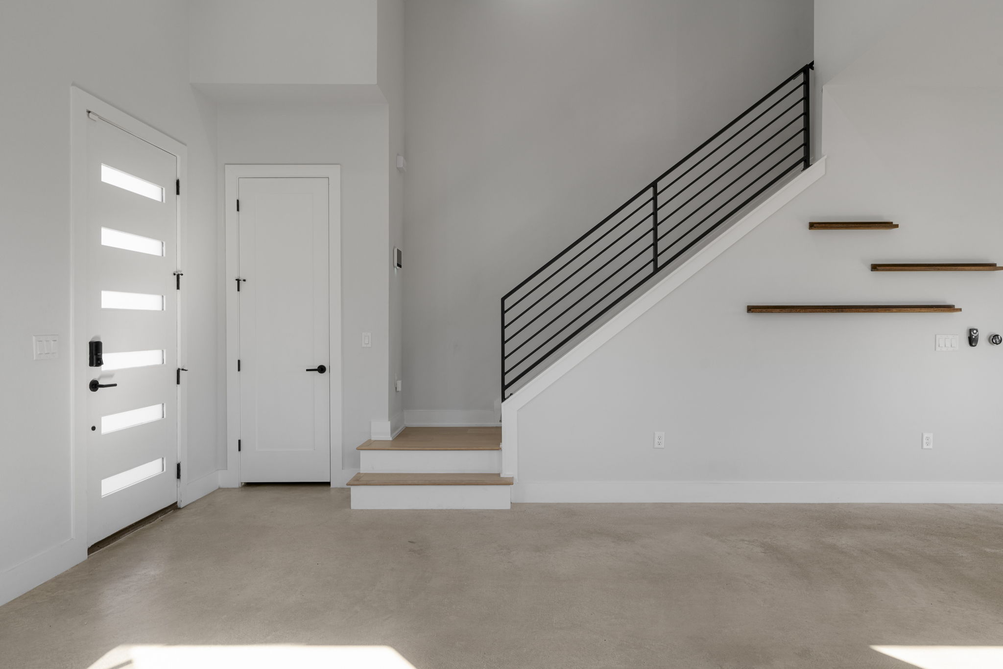 1405 Perez Street, Unit 1 Austin, TX 78721 - Photo 10 of 31 Contemporary staircase with wood treads and metal railing adds architectural interest, complemented by floating accent shelves and minimalist finishes.