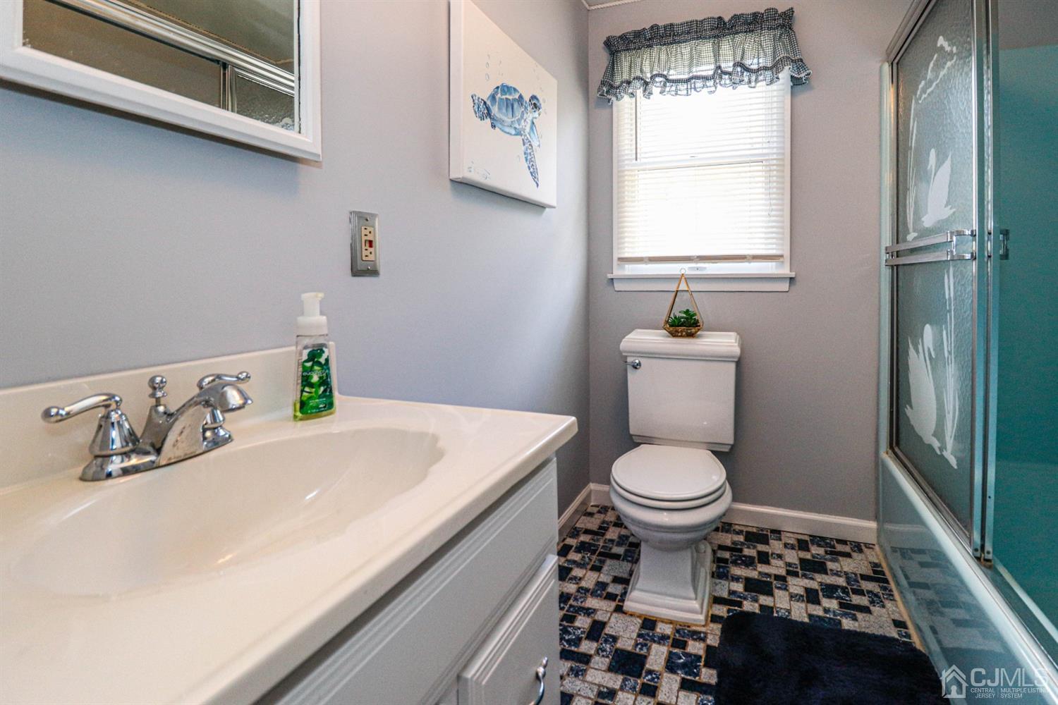 3 Avon Road Edison, NJ 08817 - Photo 26 of 39 a bathroom with a sink a toilet and window