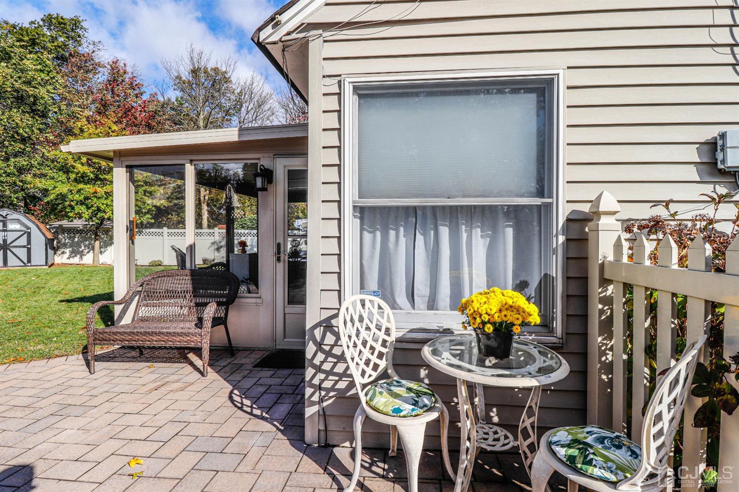 3 Avon Road Edison, NJ 08817 - Photo 35 of 39 a view of a patio with table and chairs potted plants with wooden fence