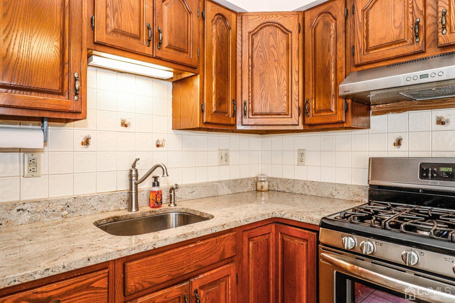 3 Avon Road Edison, NJ 08817 - Photo 10 of 39 a kitchen with granite countertop a sink stainless steel appliances wooden floor and a counter top space