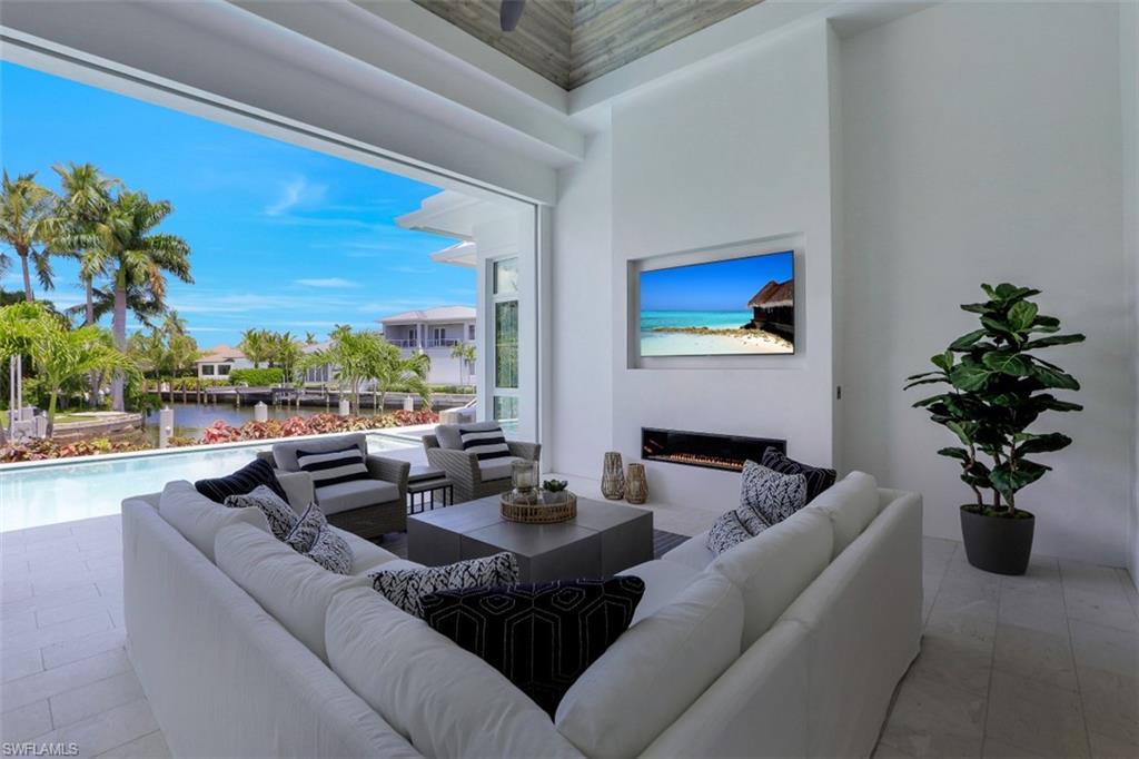 2130 Tarpon Road Naples, FL 34102 - Photo 12 of 35 a living room with couches a coffee table and a potted plant