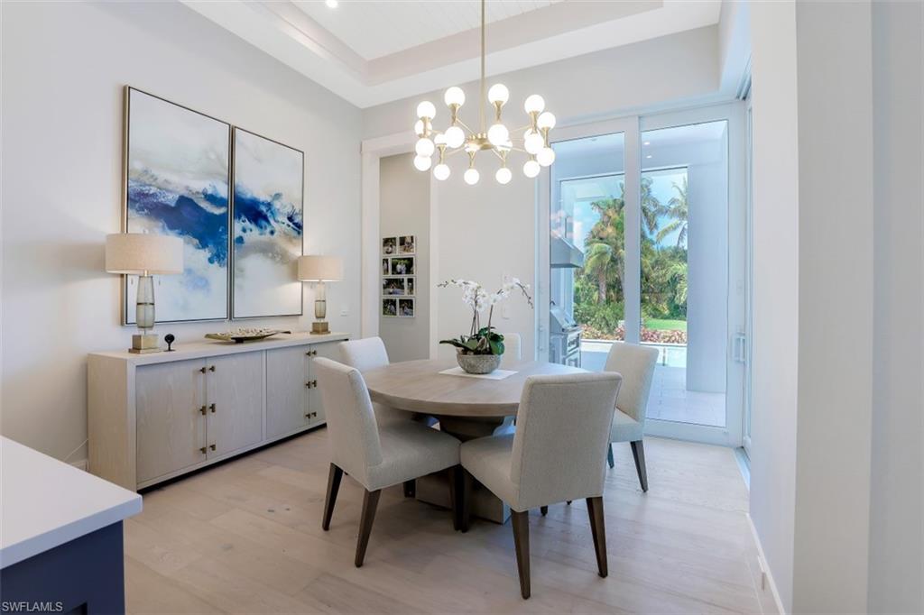 2130 Tarpon Road Naples, FL 34102 - Photo 19 of 35 a view of a dining room with furniture and chandelier