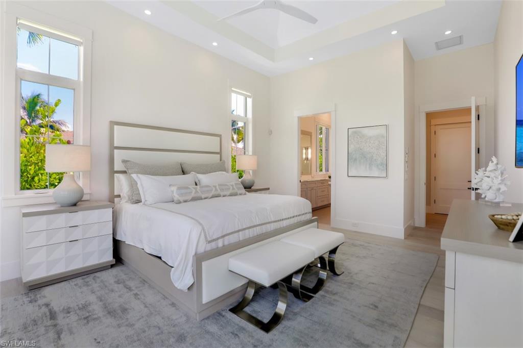2130 Tarpon Road Naples, FL 34102 - Photo 20 of 35 a bedroom with a bed and a couch