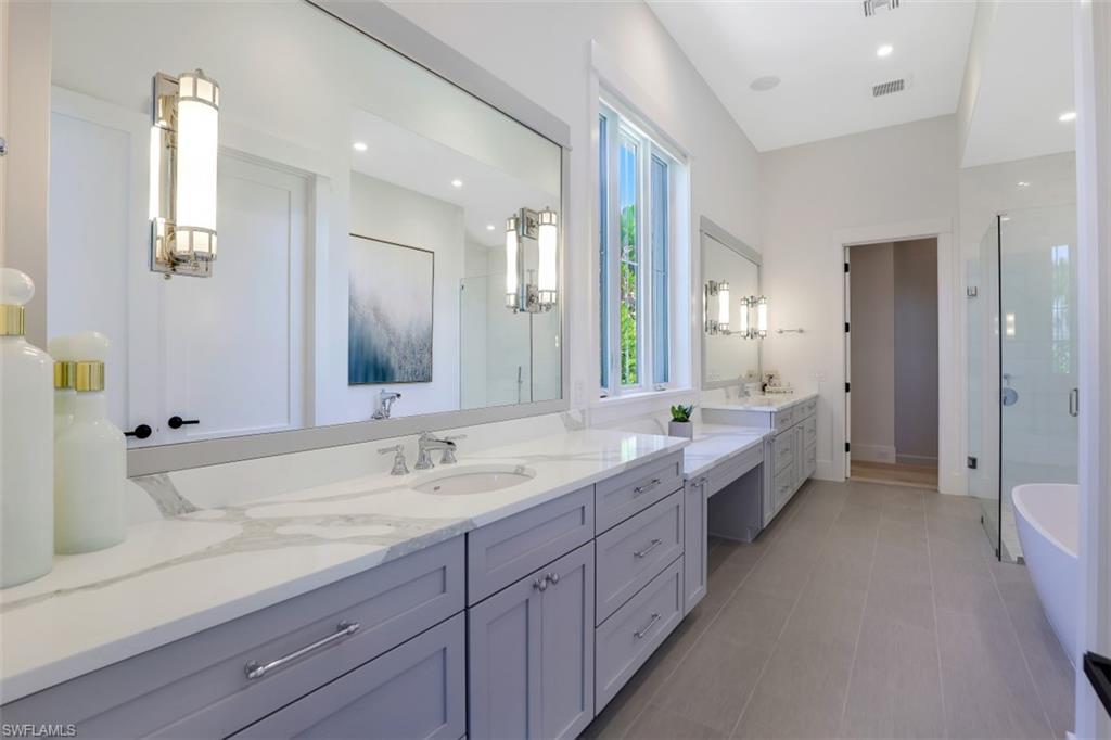 2130 Tarpon Road Naples, FL 34102 - Photo 21 of 35 a spacious bathroom with a granite countertop double vanity sink a mirror and a bathtub