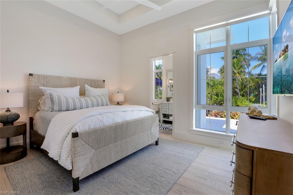 2130 Tarpon Road Naples, FL 34102 - Photo 24 of 35 a bedroom with a bed and a couch