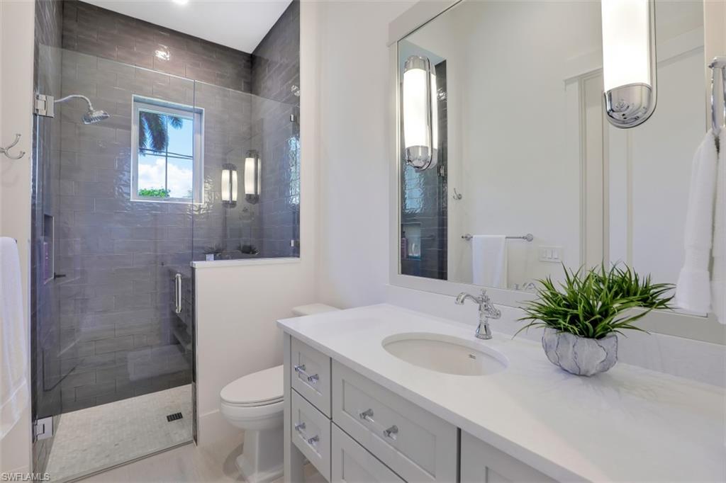 2130 Tarpon Road Naples, FL 34102 - Photo 27 of 35 a bathroom with a sink a toilet and shower