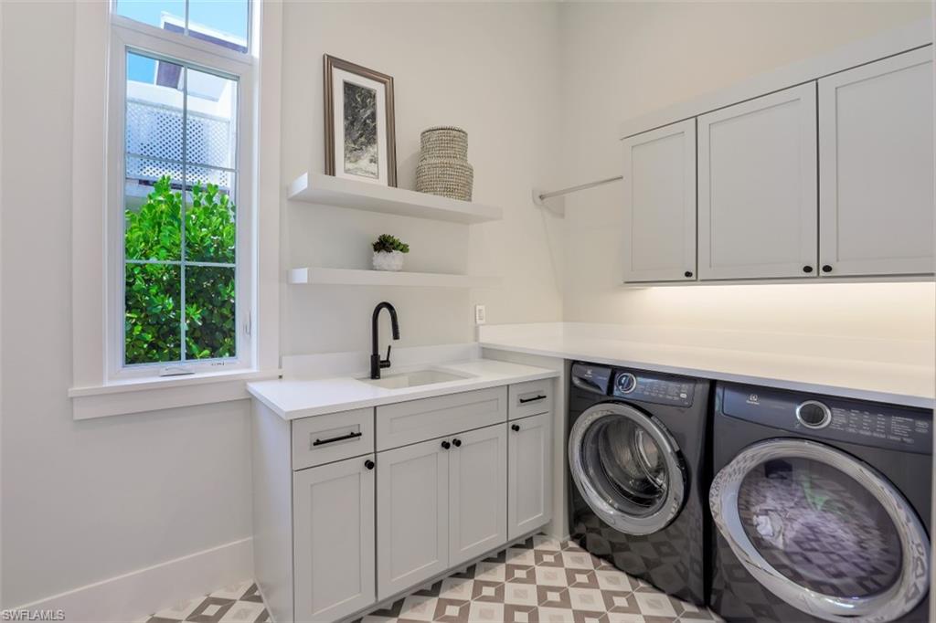 2130 Tarpon Road Naples, FL 34102 - Photo 30 of 35 a view of a storage and utility room with washer and dryer
