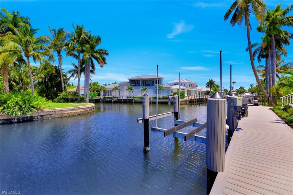 2130 Tarpon Road Naples, FL 34102 - Photo 33 of 35 a view of a lake with boats and palm trees