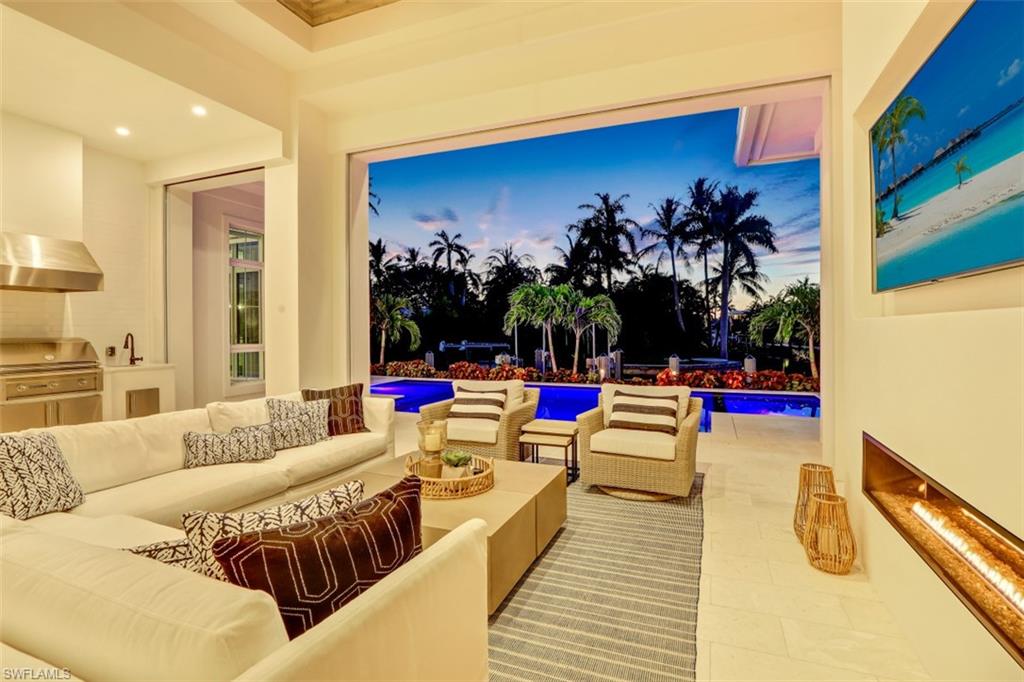 2130 Tarpon Road Naples, FL 34102 - Photo 4 of 35 a living room with patio furniture and a potted plant