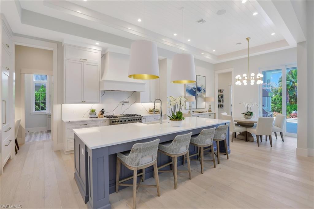 2130 Tarpon Road Naples, FL 34102 - Photo 5 of 35 a kitchen with lots of counter top space and dining table