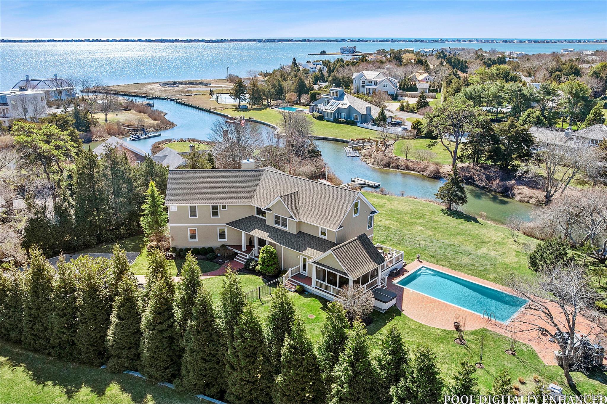 an aerial view of a house with a garden and lake view