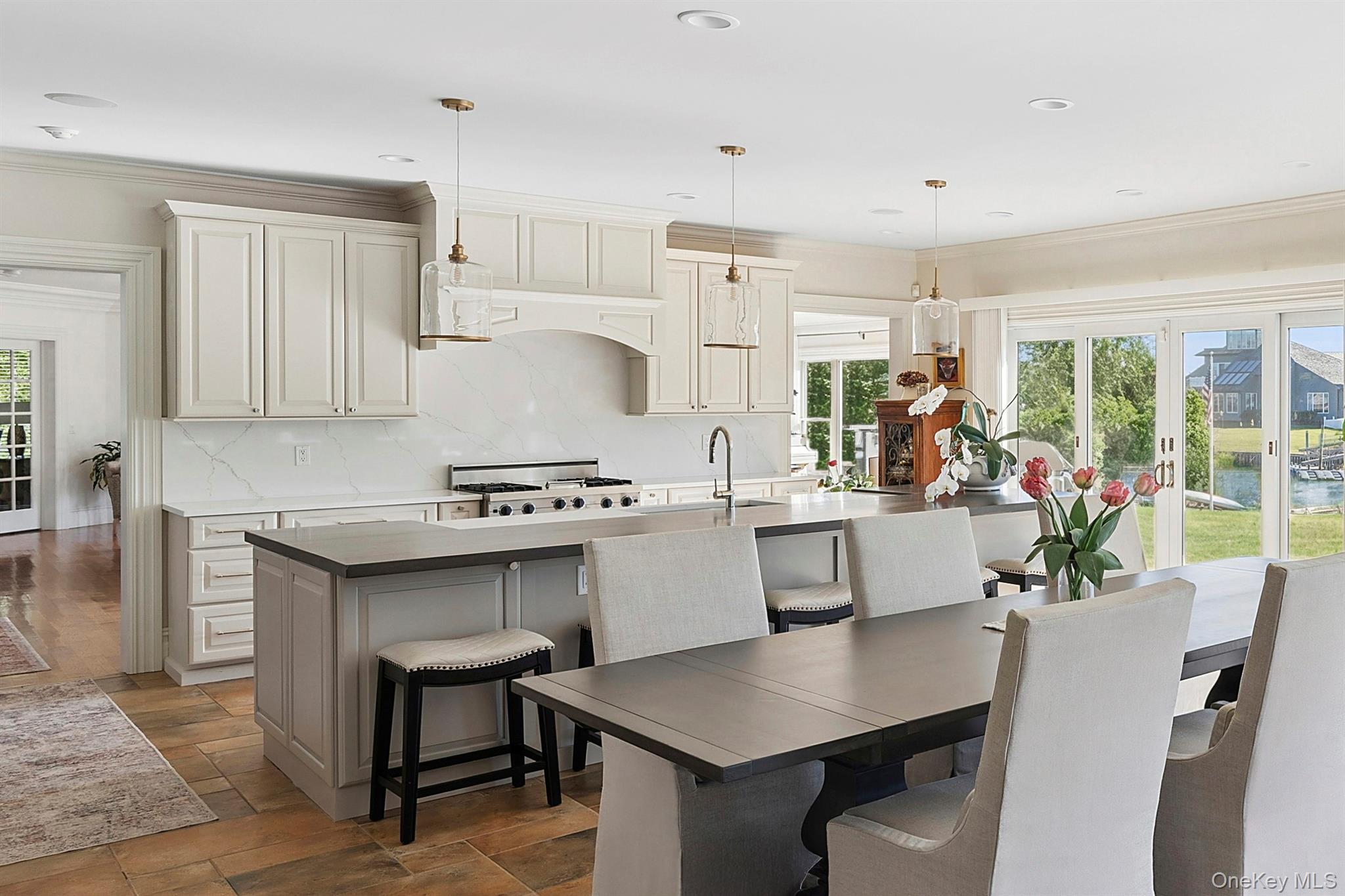 5 Woodcock Lane Remsenburg, NY 11960 - Photo 11 of 23 a kitchen with a dining table chairs and white cabinets