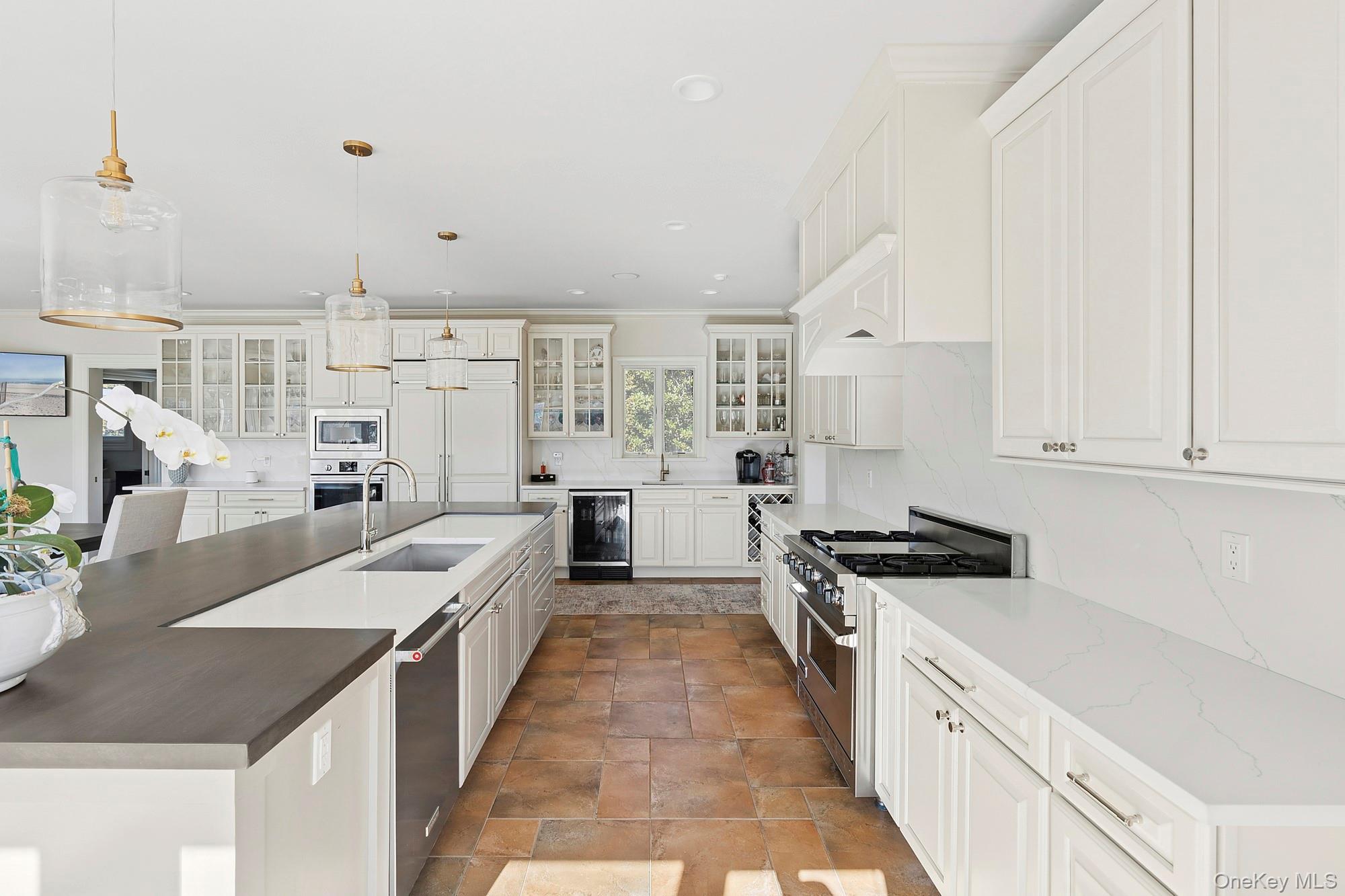 5 Woodcock Lane Remsenburg, NY 11960 - Photo 12 of 23 a large white kitchen with stainless steel appliances