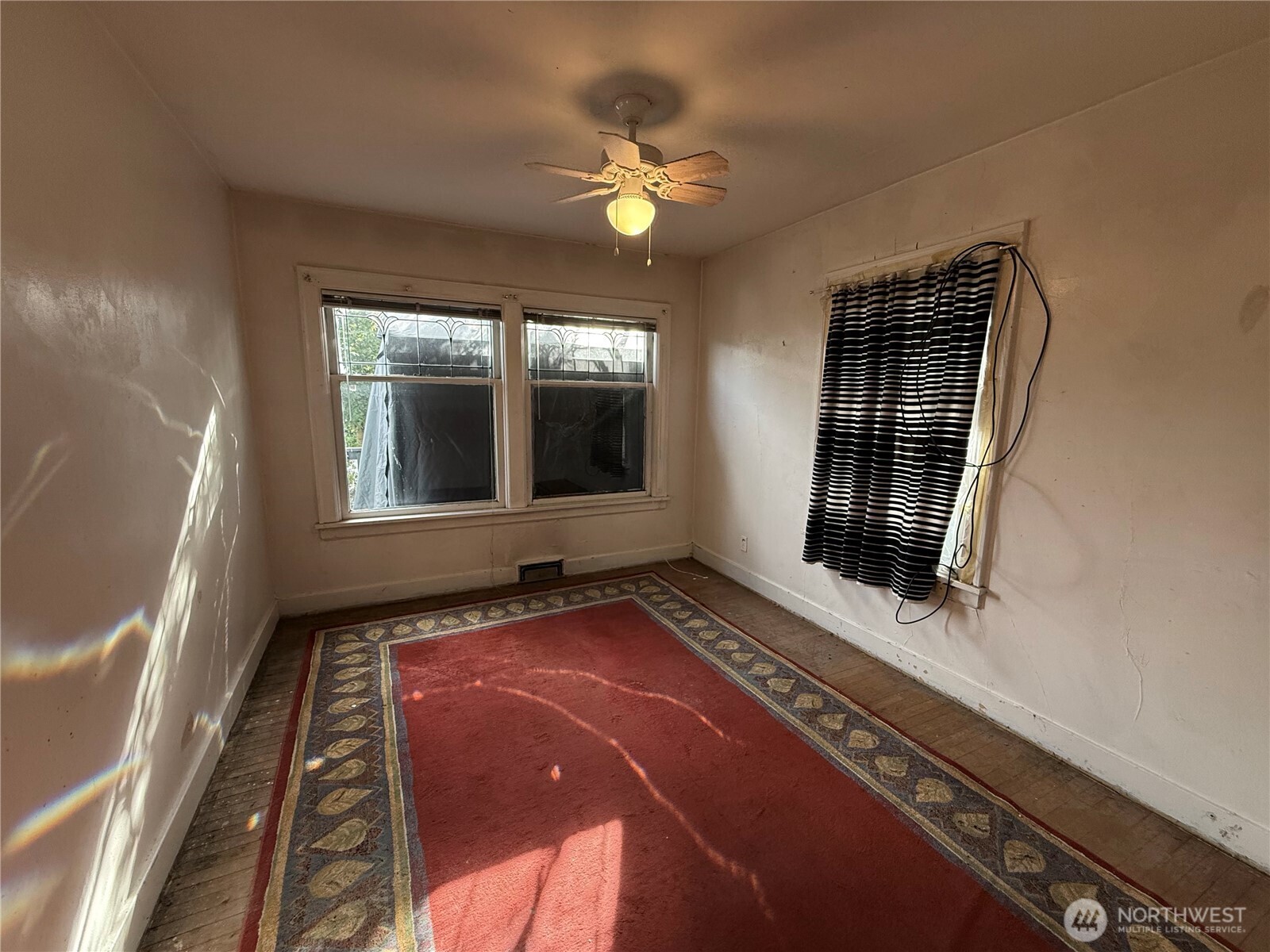 618 North 125th Street Seattle, WA 98133 - Photo 12 of 22 a view of an empty room with window and wooden floor