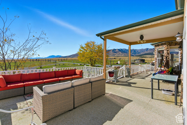4768 East Hickman Canyon Road Stockton, UT 84071 - Photo 55 of 85 View of deck and porch featuring a mountain view, an outdoor living space.