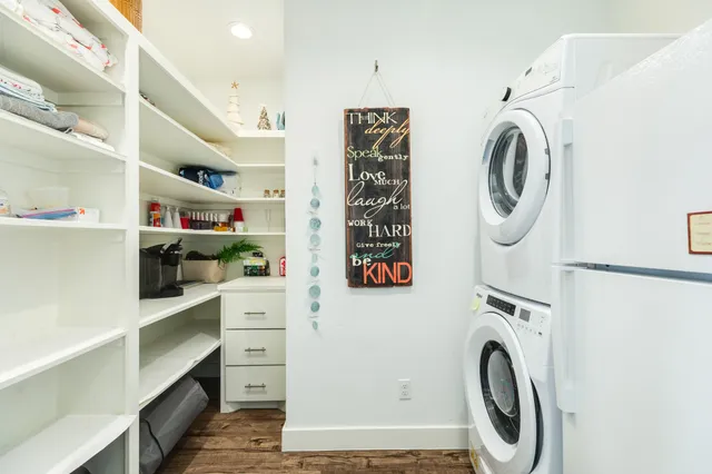 a view of washer and dryer with kitchen in the background