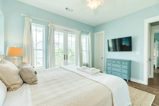 a bedroom with a bed and a flat screen tv