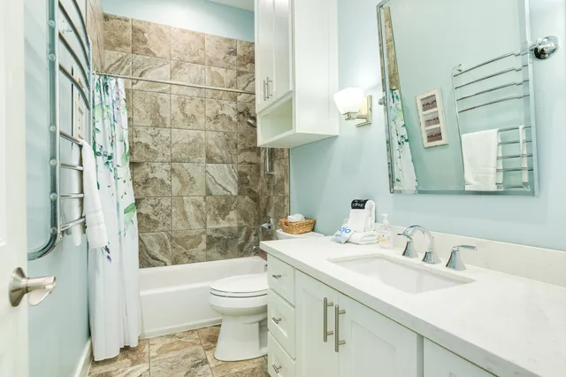 a bathroom with a sink toilet and shower