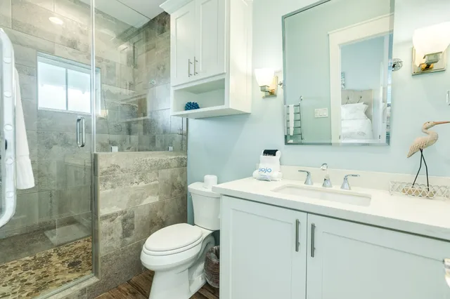 a bathroom with a sink toilet and shower