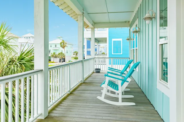 a view of two chairs in balcony of the house