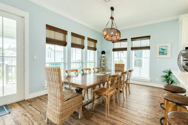 a view of a dining room with furniture wooden floor and chandelier