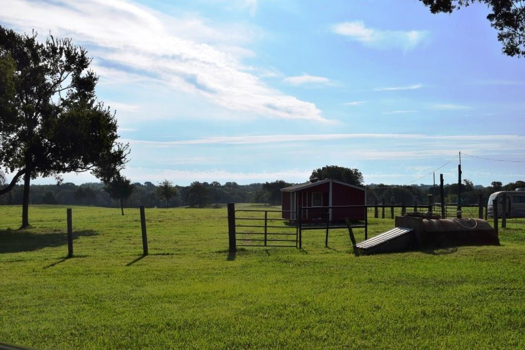 14550 Highway 78 Blue Ridge, TX 75424 - Photo 30 of 37 a view of a garden with a bench in front of the house