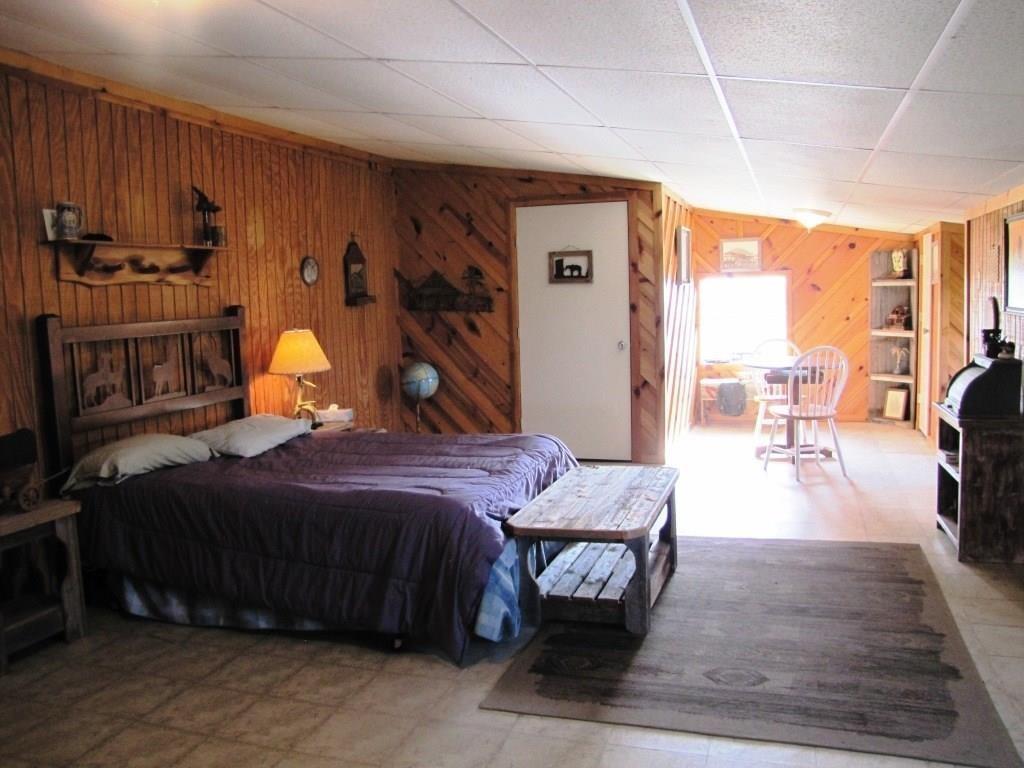 14550 Highway 78 Blue Ridge, TX 75424 - Photo 5 of 37 a bedroom with a bed and wooden floor
