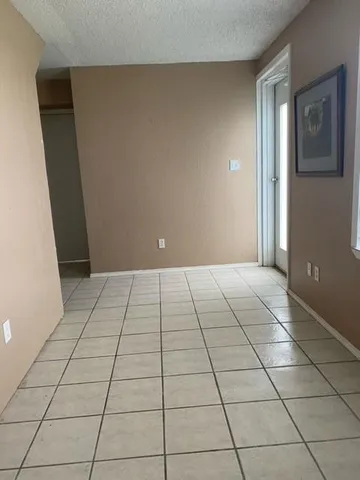 a view of a livingroom with an empty space and a rug