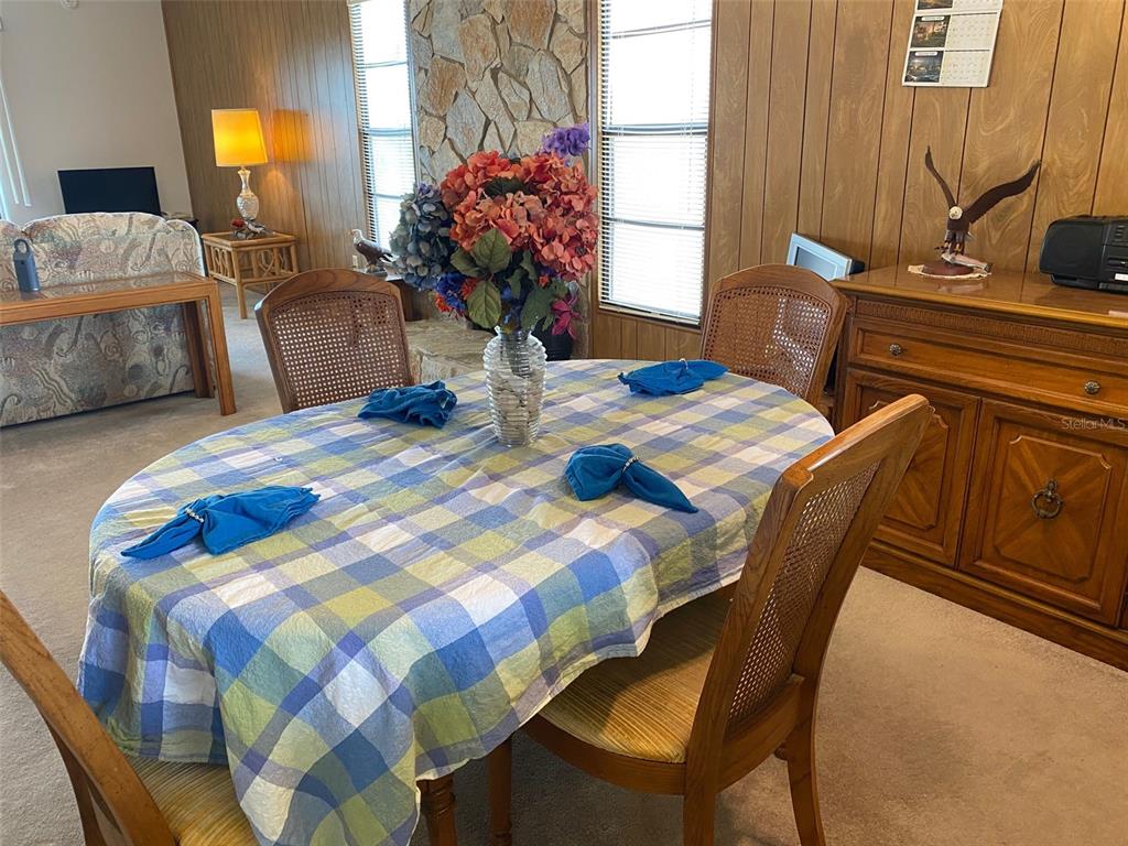 9940 Eagles Point Circle, Unit 4 Port Richey, FL 34668 - Photo 13 of 53 a bedroom with a bed and dresser with mirror