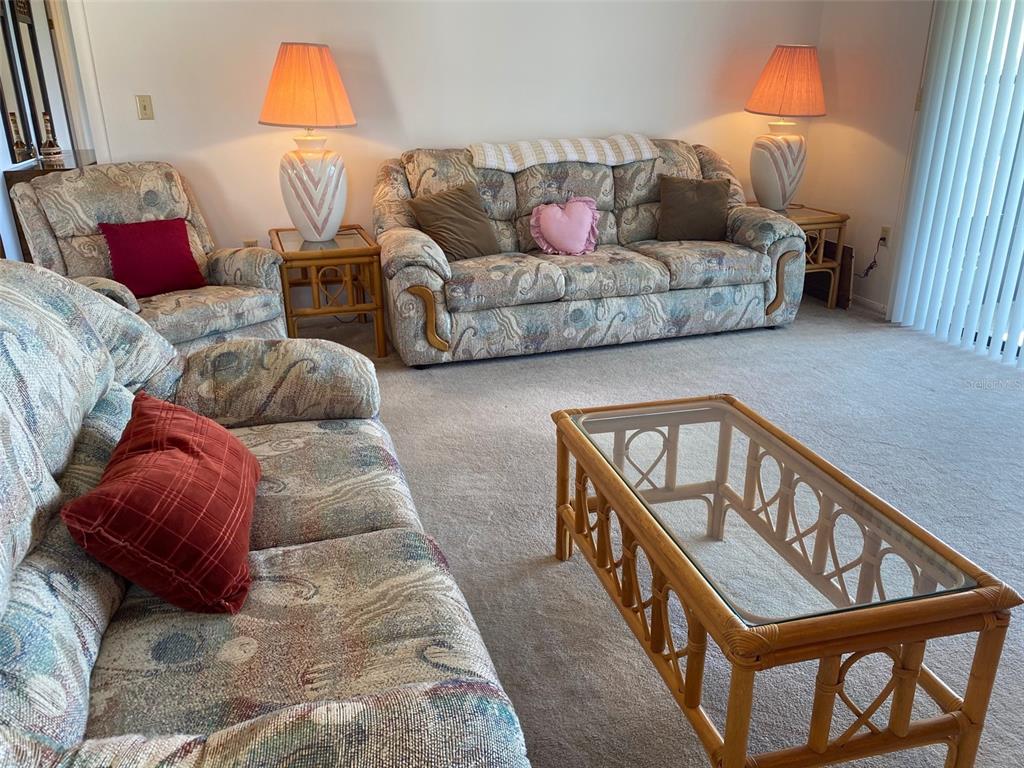9940 Eagles Point Circle, Unit 4 Port Richey, FL 34668 - Photo 15 of 53 a living room with furniture a couch and a window
