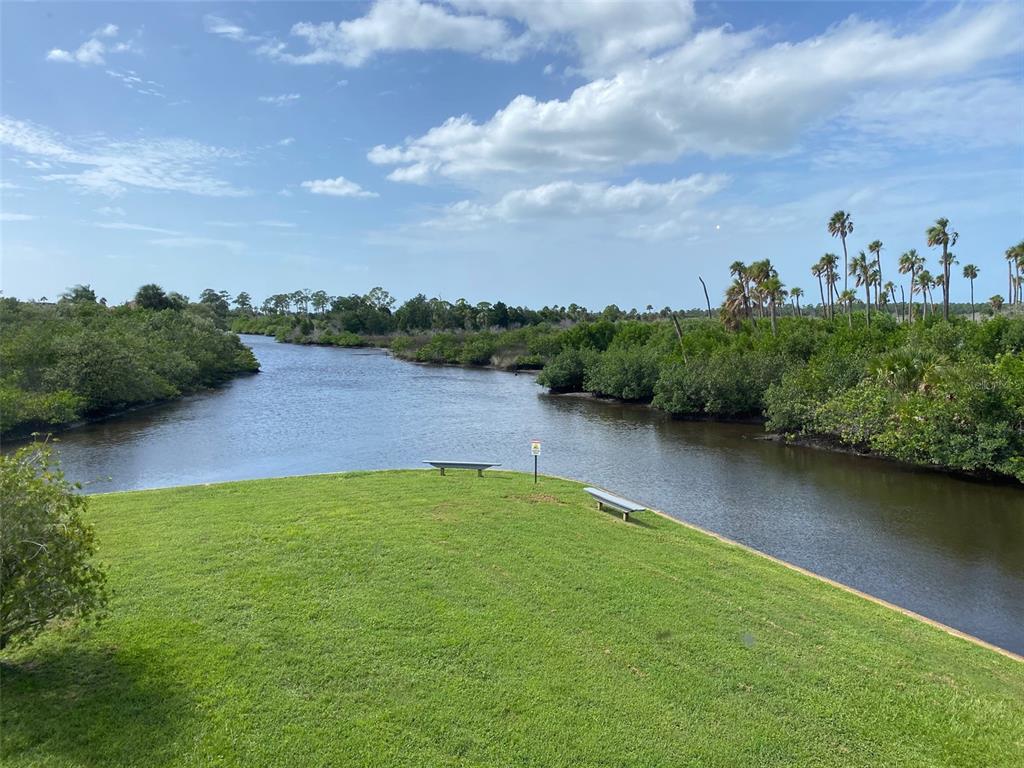 9940 Eagles Point Circle, Unit 4 Port Richey, FL 34668 - Photo 19 of 53 a view of a lake with houses in the back