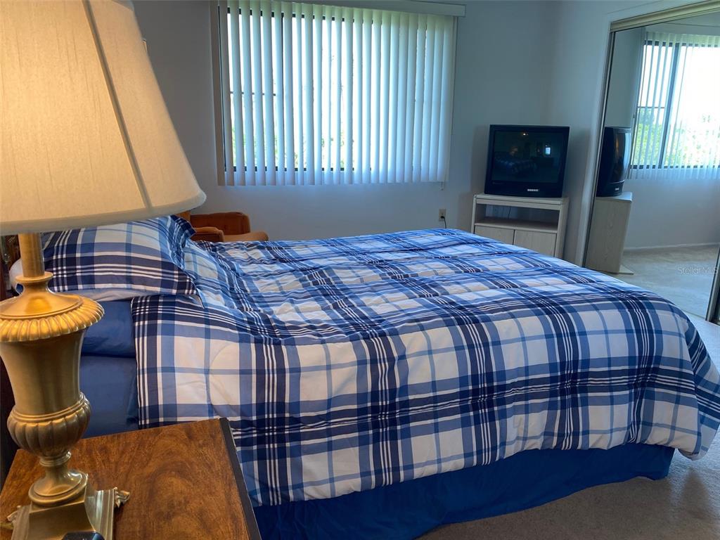 9940 Eagles Point Circle, Unit 4 Port Richey, FL 34668 - Photo 20 of 53 a bedroom with a bed and a television