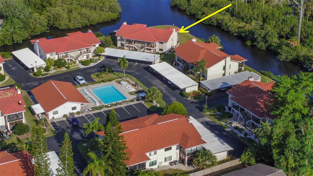 9940 Eagles Point Circle, Unit 4 Port Richey, FL 34668 - Photo 2 of 53 an aerial view of residential houses with outdoor space