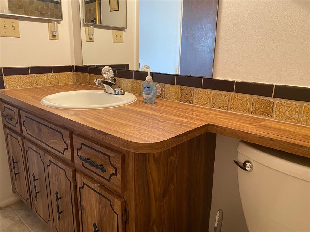 9940 Eagles Point Circle, Unit 4 Port Richey, FL 34668 - Photo 23 of 53 a bathroom with a sink and a mirror