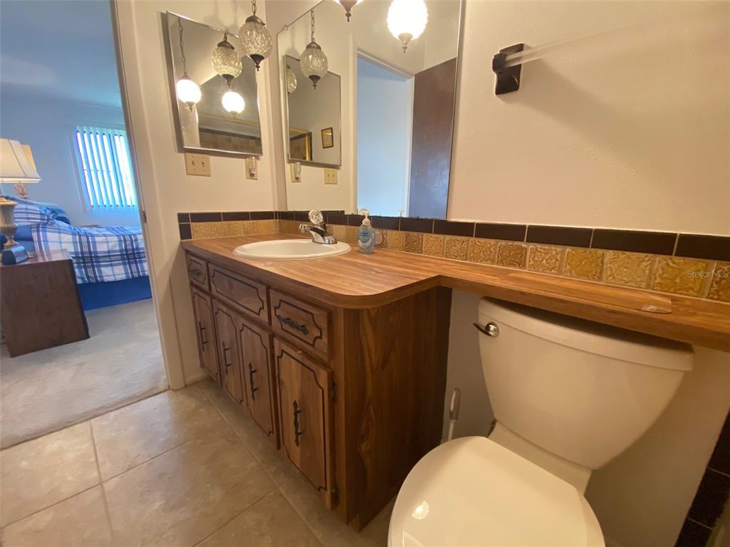 9940 Eagles Point Circle, Unit 4 Port Richey, FL 34668 - Photo 24 of 53 a bathroom with a toilet sink and mirror