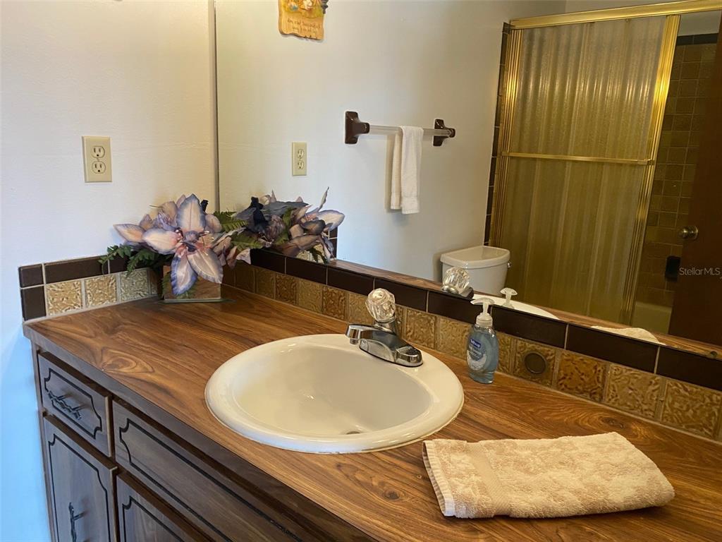 9940 Eagles Point Circle, Unit 4 Port Richey, FL 34668 - Photo 28 of 53 a bathroom with a sink and a mirror