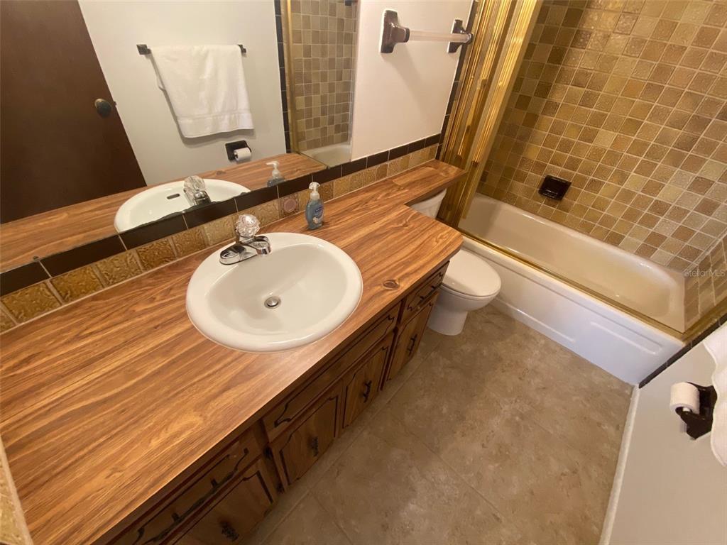 9940 Eagles Point Circle, Unit 4 Port Richey, FL 34668 - Photo 30 of 53 a bathroom with a sink and a mirror