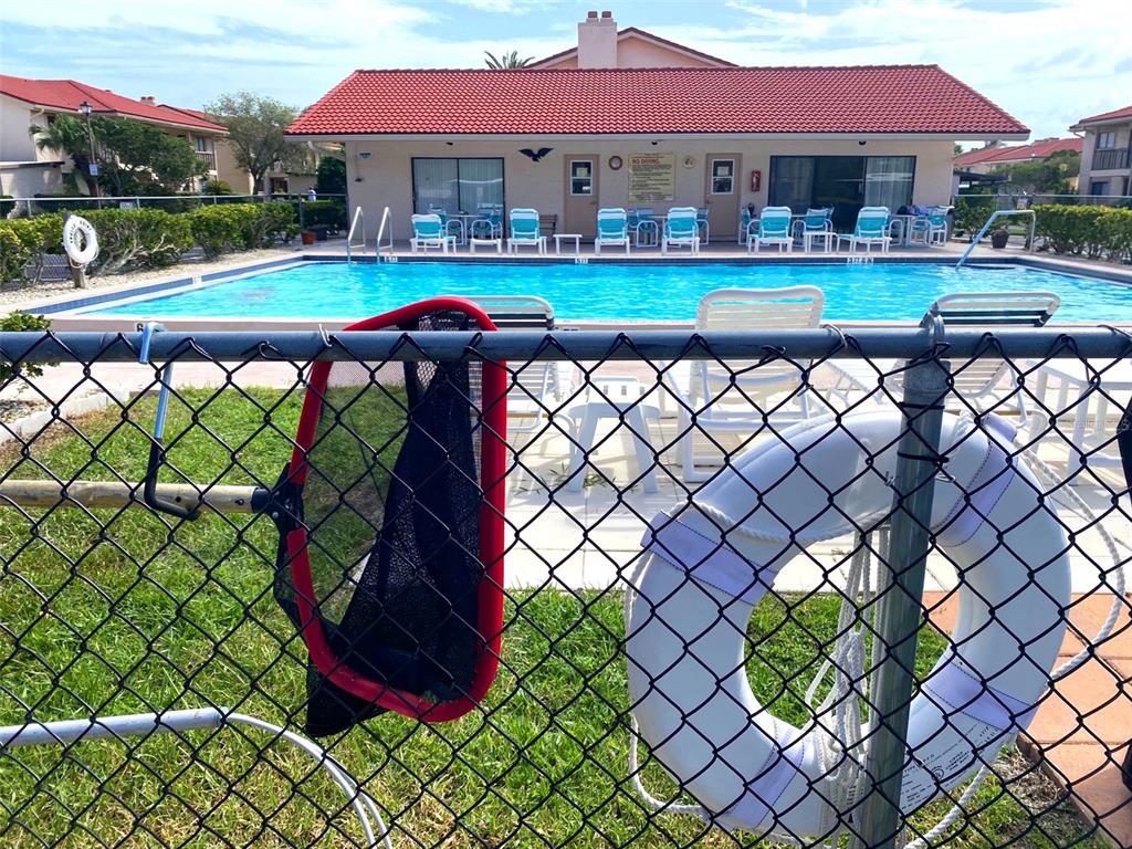 9940 Eagles Point Circle, Unit 4 Port Richey, FL 34668 - Photo 3 of 53 a front view of a house with a yard