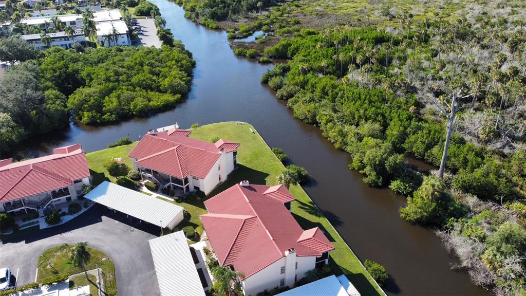9940 Eagles Point Circle, Unit 4 Port Richey, FL 34668 - Photo 42 of 53 an aerial view of a house with yard swimming pool and outdoor seating