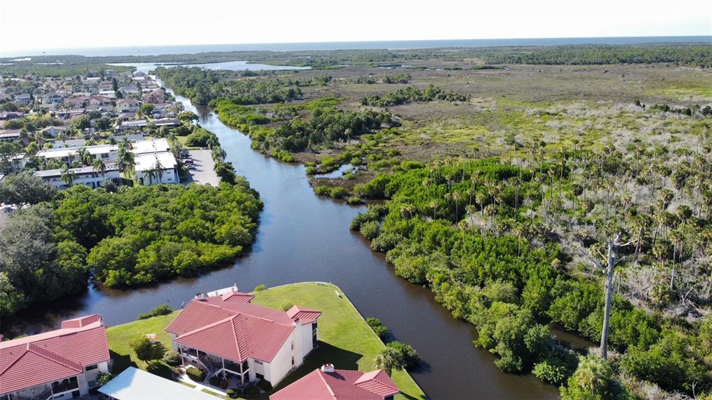 9940 Eagles Point Circle, Unit 4 Port Richey, FL 34668 - Photo 43 of 53 an aerial view of a house with a lake view