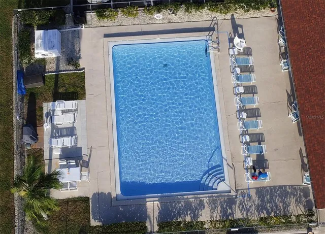 an aerial view of a house with a yard and lake view