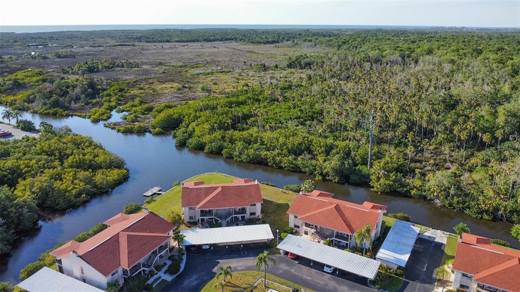 9940 Eagles Point Circle, Unit 4 Port Richey, FL 34668 - Photo 50 of 53 an aerial view of residential house with outdoor space and lake view