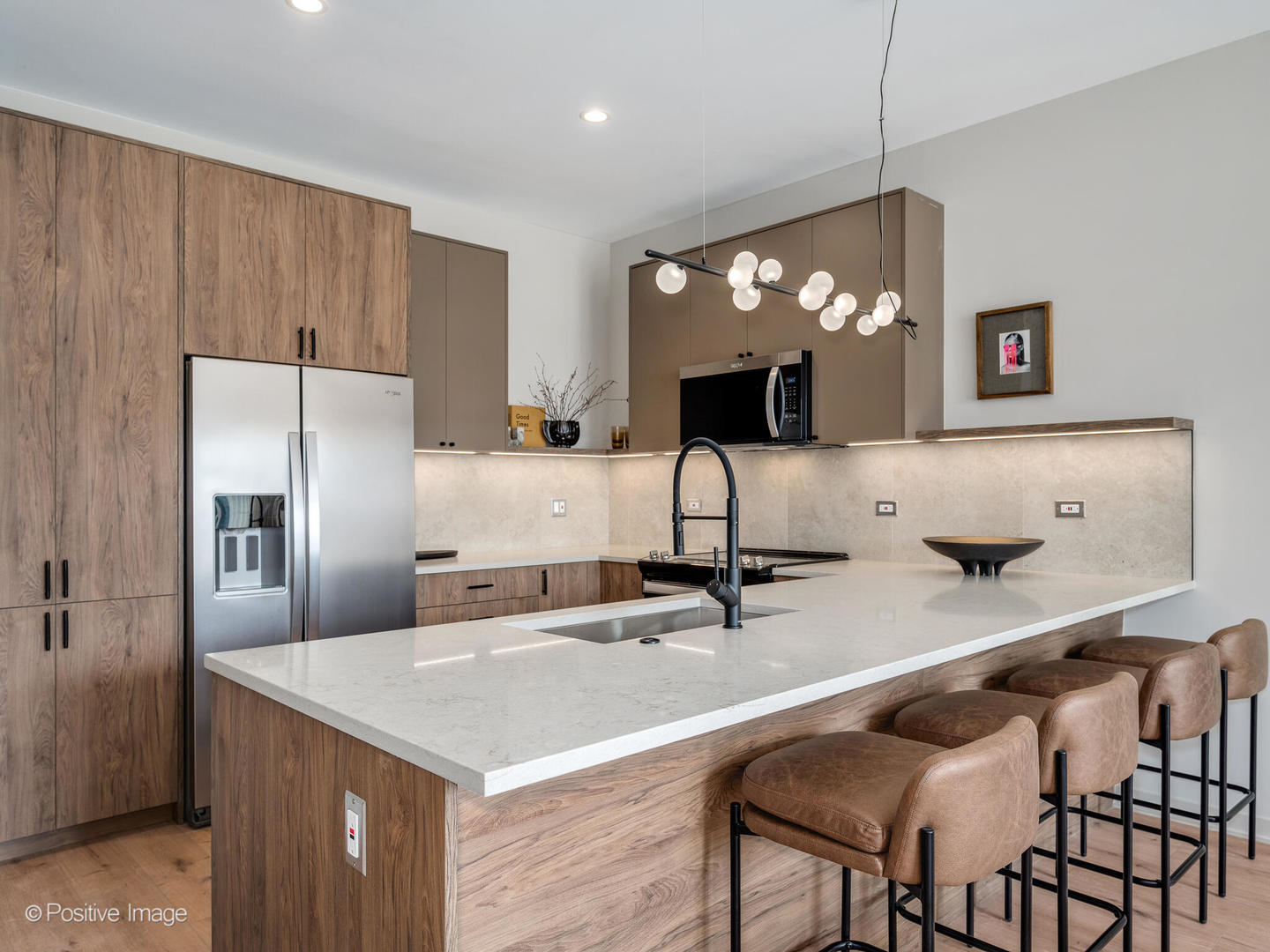 1235 North Ashland Avenue, Unit 301 Chicago, IL 60622 - Photo 13 of 25 a kitchen with kitchen island a sink counter top space appliances and cabinets
