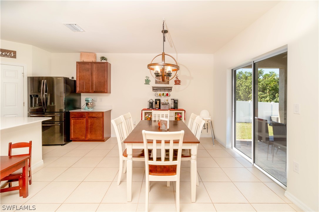 8117 Sandpiper Road Fort Myers, FL 33967 - Photo 8 of 13 a kitchen with stainless steel appliances a stove top oven a sink a counter top space and cabinets