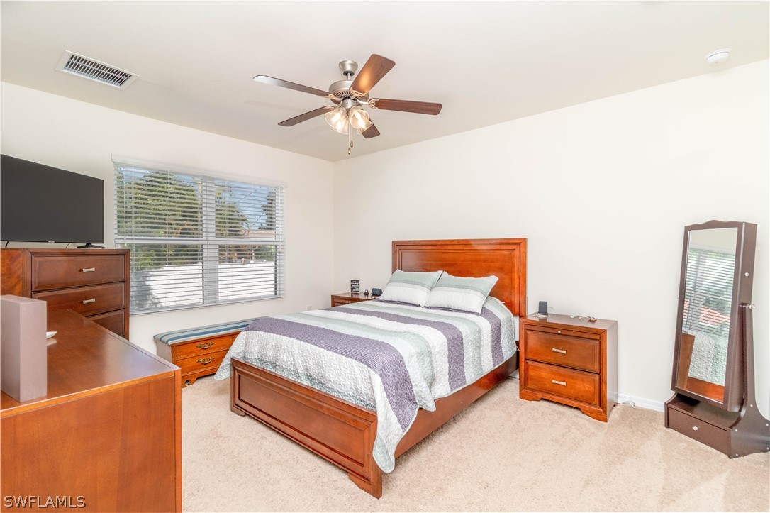 8117 Sandpiper Road Fort Myers, FL 33967 - Photo 9 of 13 a bedroom with a bed and wooden floor