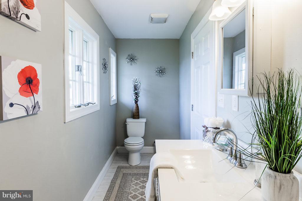 2208 Conrow Road Cinnaminson, NJ 08077 - Photo 22 of 28 a bathroom with a sink toilet and a mirror