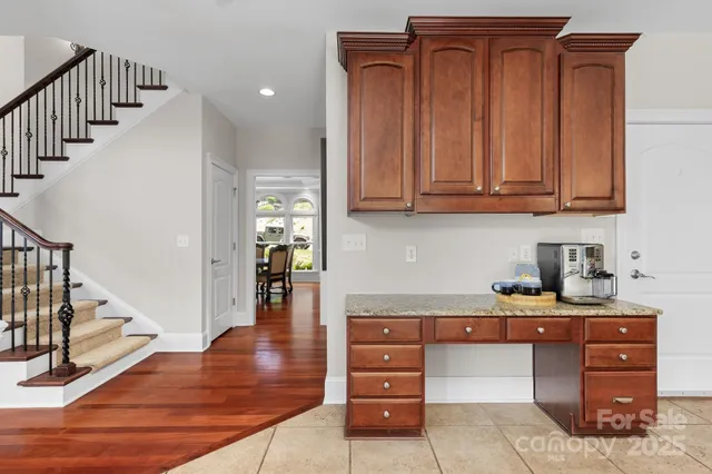 a kitchen view with wooden cabinets and entryway
