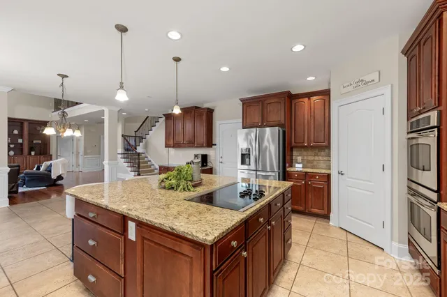 a kitchen with granite countertop cabinets and refrigerator